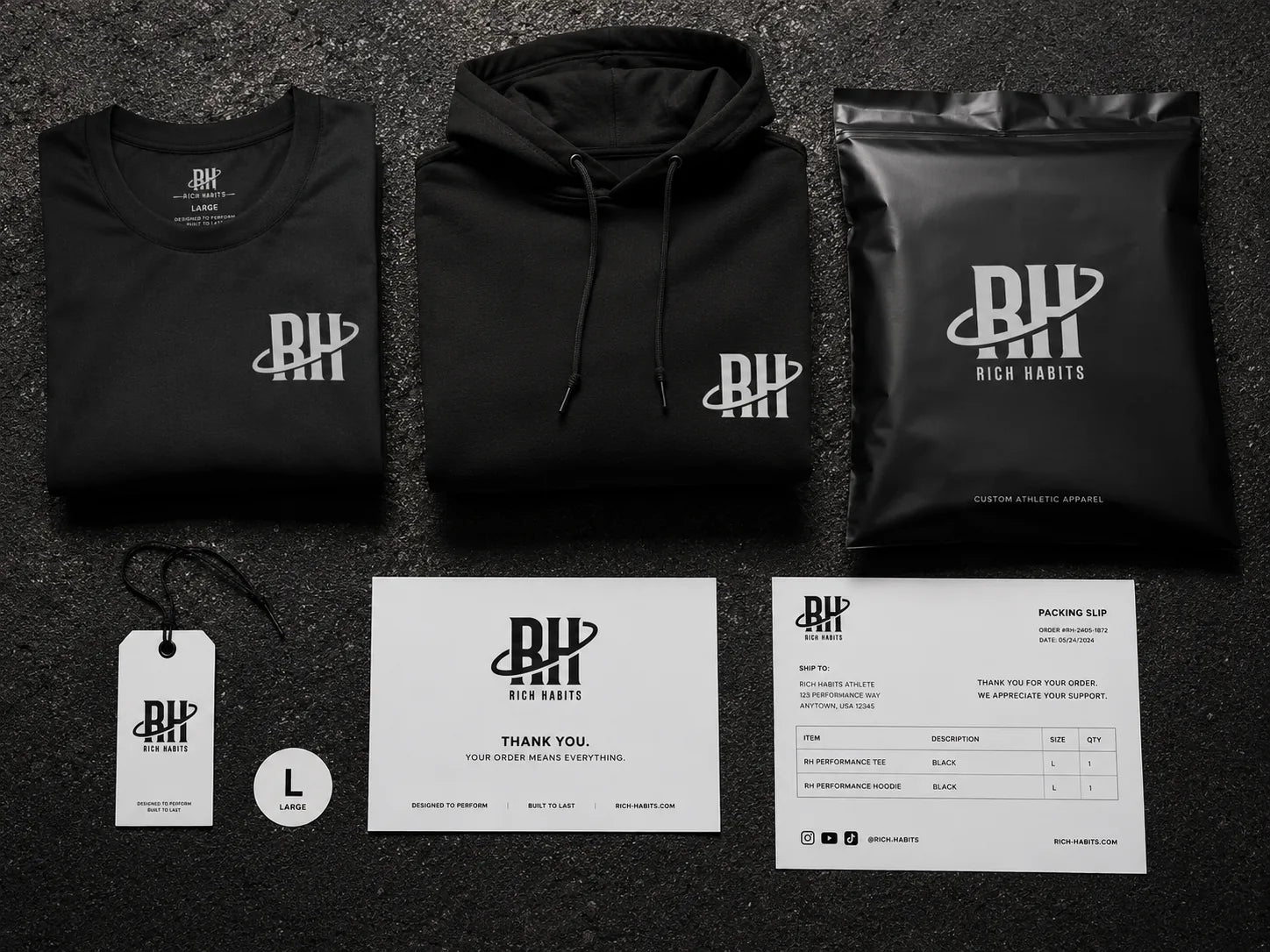 A packed Rich Habits order: a folded shirt and hoodie, a sealed mailer, a hang tag, a thank-you card and the packing slip