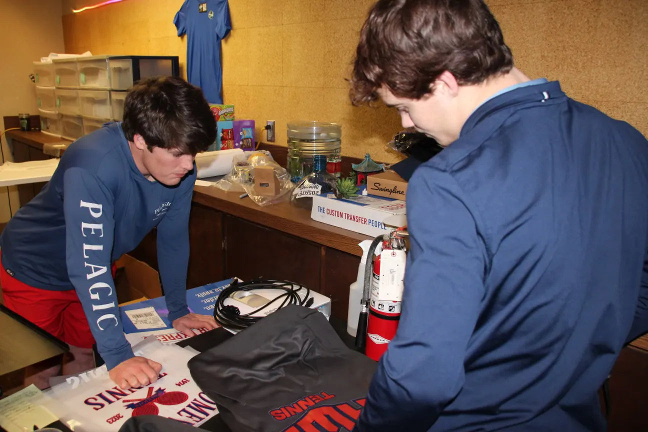 Sam Carr and Sam Sutton working over transfers at the counter