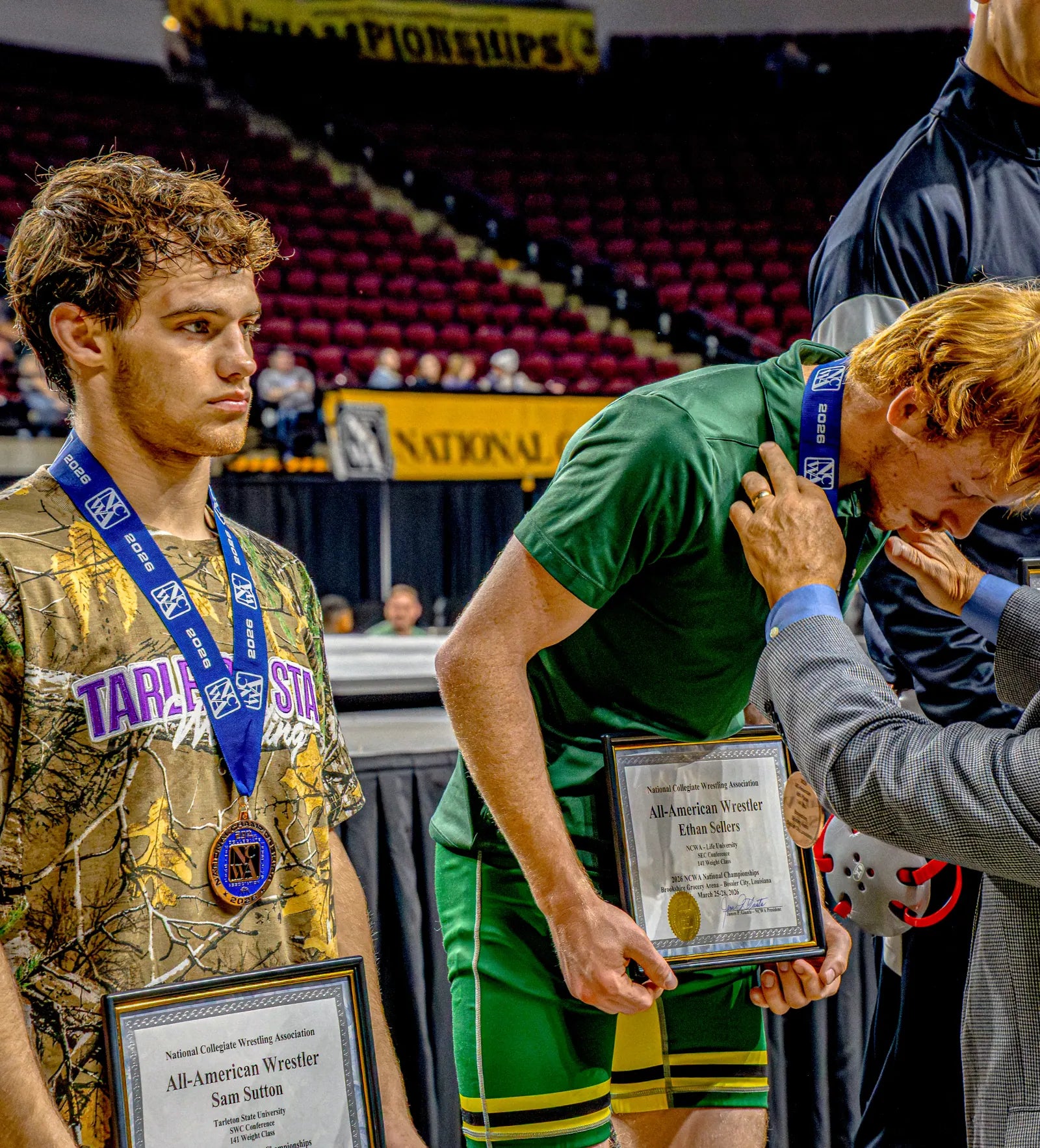 Sam Sutton holding his All-American plaque in the camo Rich Habits gear