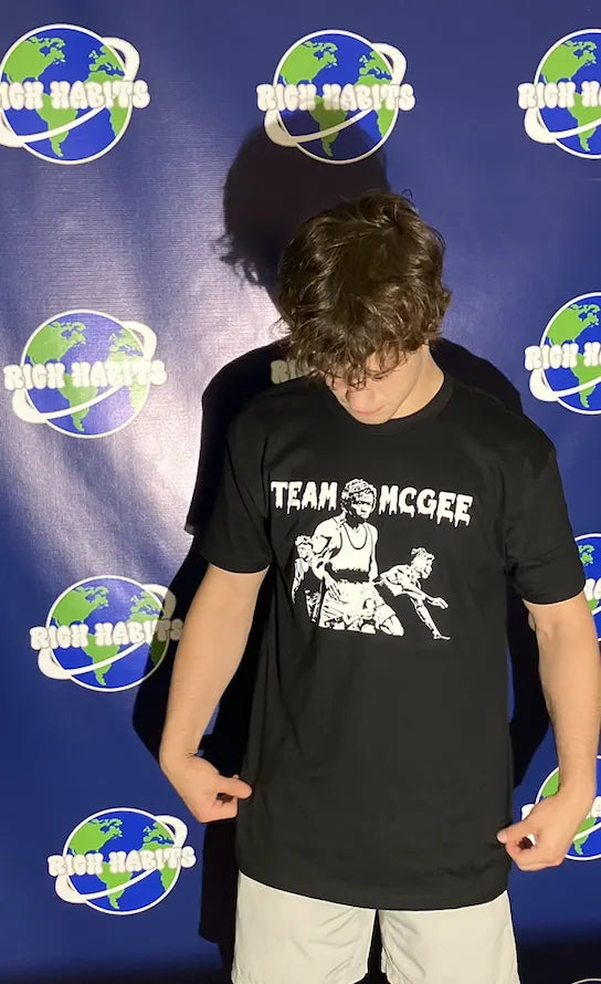 Sam Sutton in the Team McGee tee in front of the globe backdrop