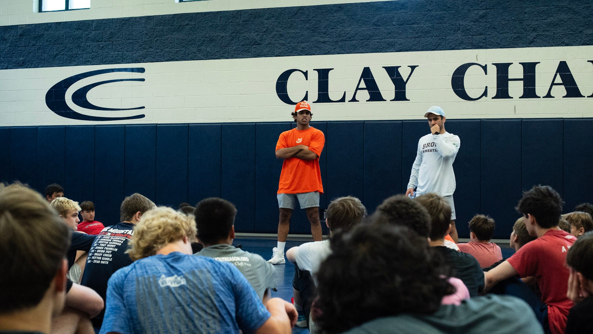 Full crowd of athletes listening to coaches