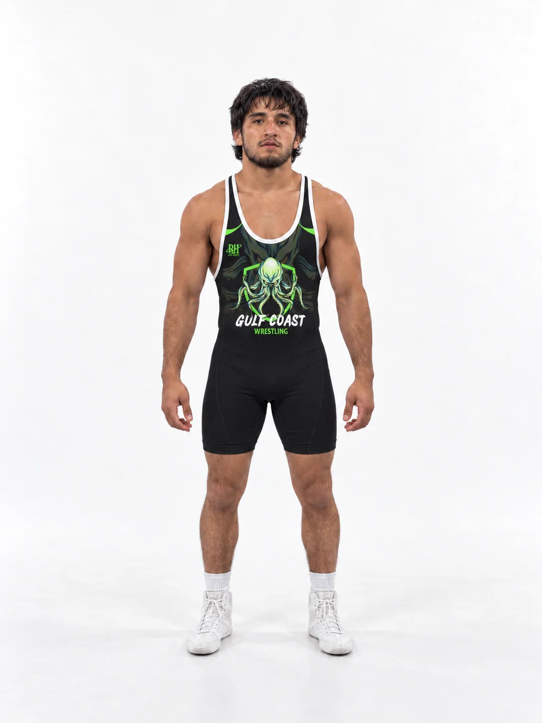 Athlete in a black and green Gulf Coast wrestling singlet